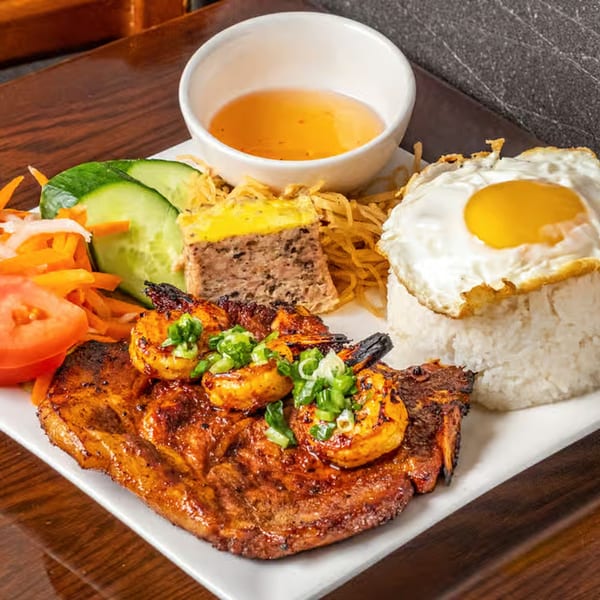 Anise Viet Cuisine's grilled pork chop and shrimp with rice, fried egg, and vegetables.